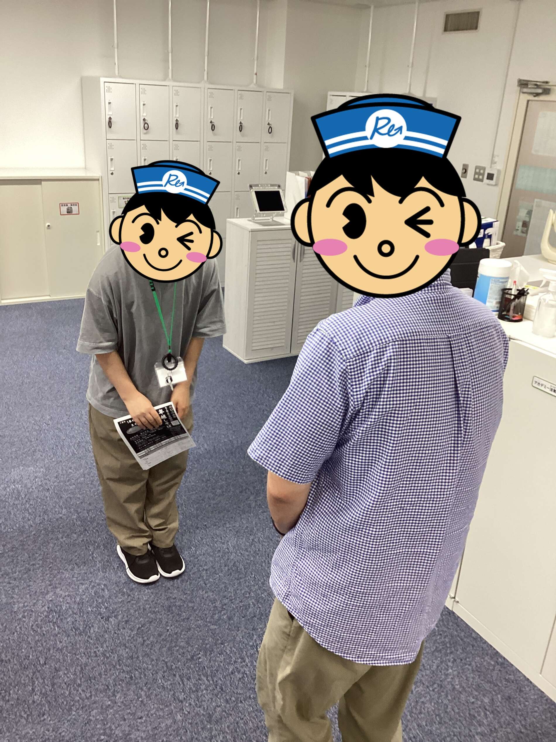 Two people in an office with tall white lockers in the background; cartoon avatars cover their faces.