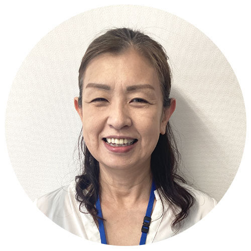 Smiling Asian woman with dark hair and a blue lanyard, circular portrait against a light background.